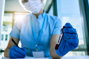 Epidemiologist analyzing a blood sample in a clinical laboratory