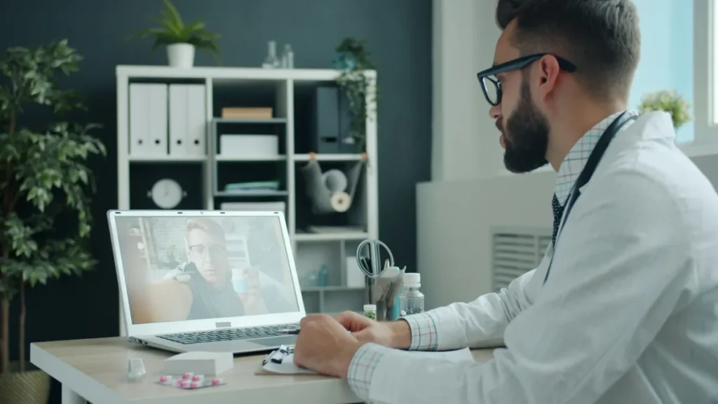 Clinician holding a video visit on a laptop, an example of remote psychiatric nurse practitioner staffing for telehealth programs