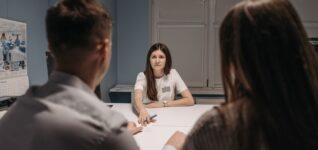 Clinic staff meet in a healthcare office to discuss how to choose a mental health staffing agency